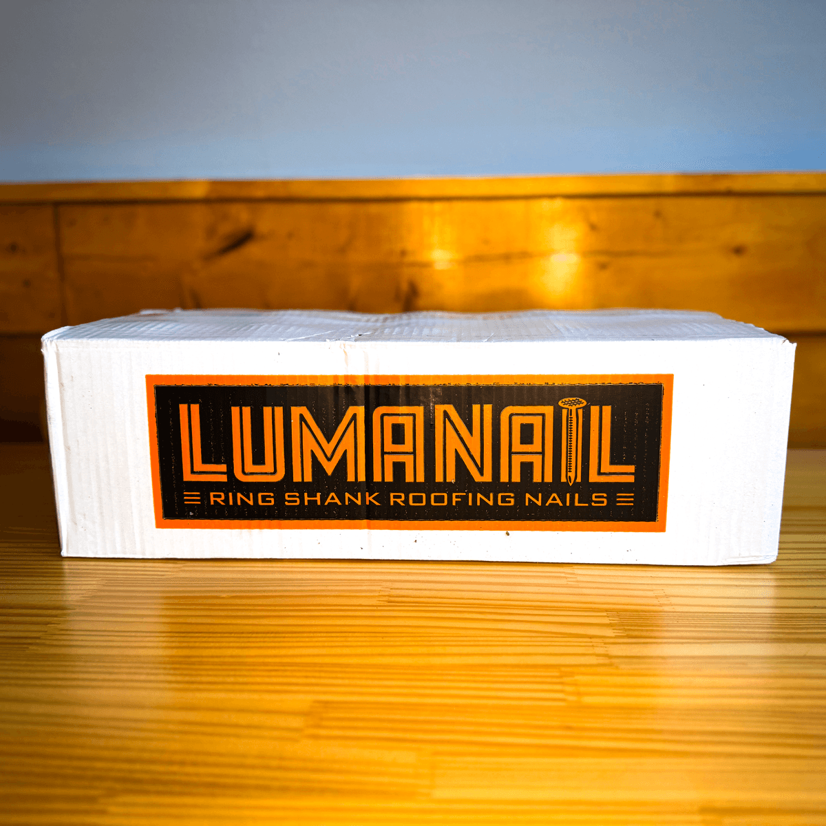 A sealed case of LumaNail ring shank roofing nails, branded in orange and black.